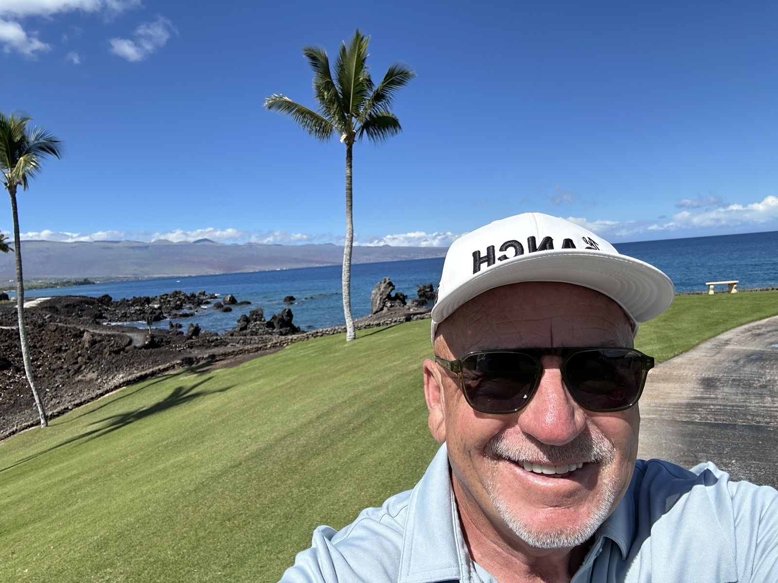 Brent under palm trees by the ocean